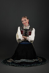 Fototapeta premium Beautiful woman wearing traditional Eastern Europe folk costumes. Slovak folk costumes.