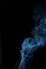 blue smoke from incense on a black background