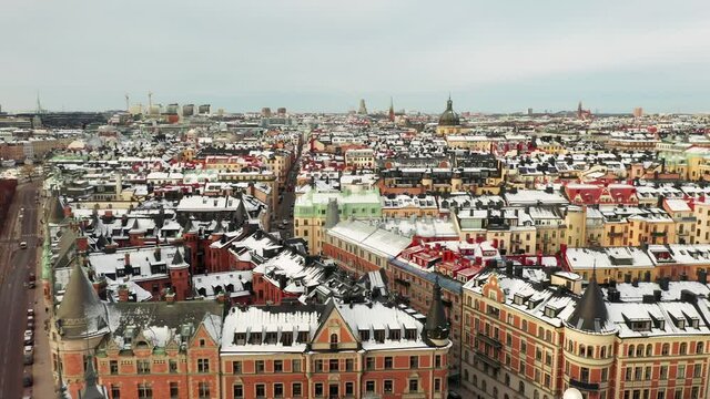 Aerial drone view in winter with snow on rooftops. Ostermalm central Stockholm