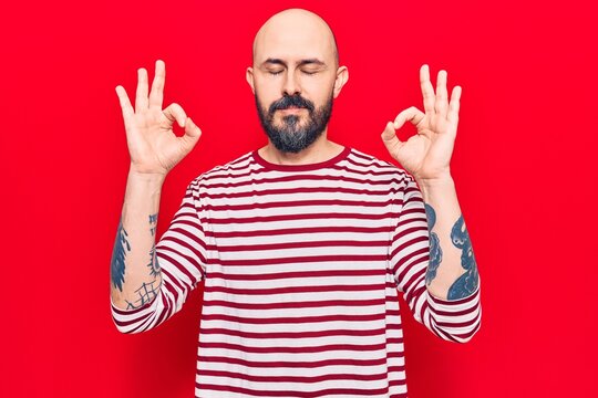 Young handsome man wearing casual clothes relax and smiling with eyes closed doing meditation gesture with fingers. yoga concept.