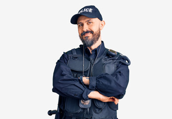 Young handsome man wearing police uniform happy face smiling with crossed arms looking at the...