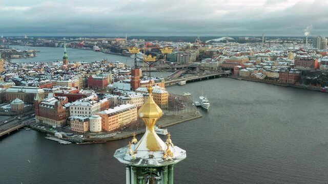 Stockholm city hall and old town in aerial drone shot on snowy winter day