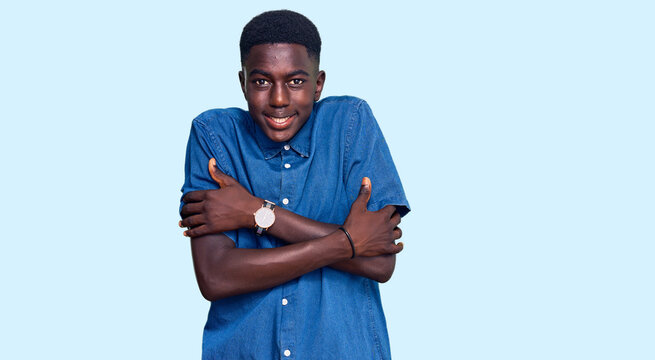 Young african american man wearing casual clothes shaking and freezing for winter cold with sad and shock expression on face