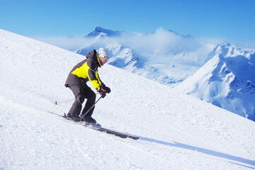 Fototapeta na wymiar Alpine skier on piste ride downhill