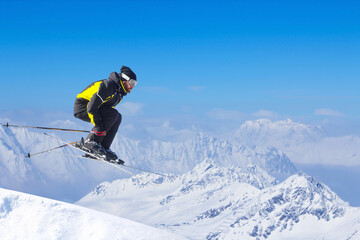 Naklejka na ściany i meble Jumping skier at mountains