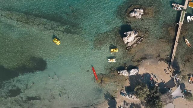 Aerial drone video of sandy beach blue sea water, clear blue sky Paros island Cyclades, Greece