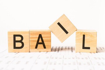 Word bail. Wooden small cubes with letters isolated on white background with copy space available