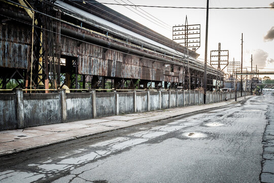 Dramatic Wide Angle Shot Of Abandoned Industrial Factory With Decaying Wall In Blue Collar Midwest