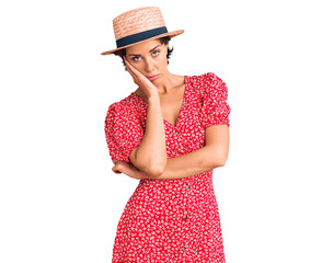 Young beautiful woman wearing summer hat thinking looking tired and bored with depression problems with crossed arms.