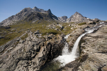 Fototapeta na wymiar Waterfall and Mountain Landscape, Aappilattoq, Greenland