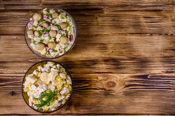 Set of festive mayonnaise salads on wooden table. Top view