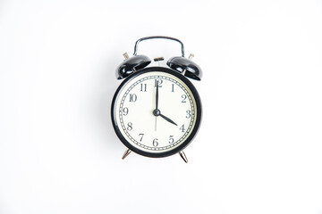 black alarm clock with white dial, 4 o'clock, isolate on white