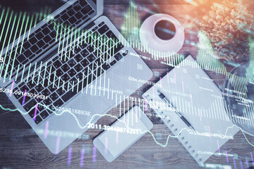 Financial market graph and top view computer on the desktop background. Double exposure. Investment concept.