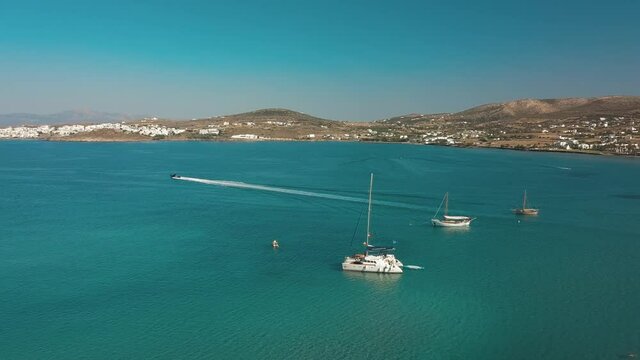 Aerial drone video of sandy beach blue sea water, clear blue sky Paros island Cyclades, Greece