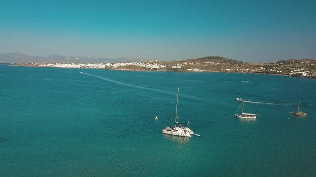 Aerial drone video of sandy beach blue sea water, clear blue sky Paros island Cyclades, Greece