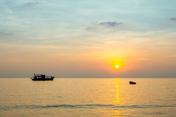 Sunset of the Sea with a ship and a boat. Thailand, Gulf of Thailand.