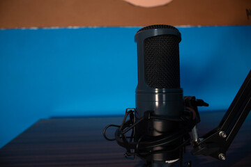 
black studio microphone on subject with its black metal arm
