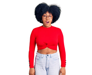 Young african american girl wearing casual clothes and glasses afraid and shocked with surprise and amazed expression, fear and excited face.