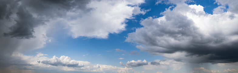 Obraz premium White cumulus clouds in blue sky panoramic high resolution background