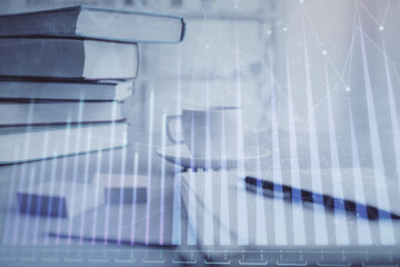 Double exposure of financial chart drawing and desktop with coffee and items on table background. Concept of forex market trading
