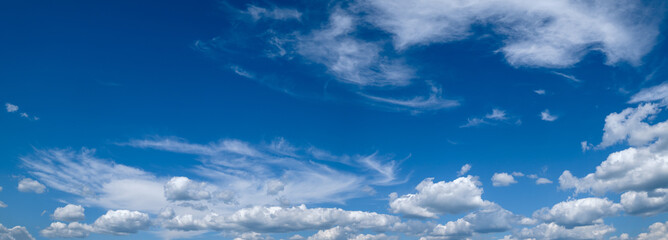 Naklejka na ściany i meble White cumulus clouds in blue sky panoramic high resolution background