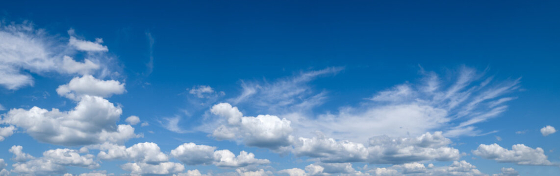 White cumulus clouds in blue sky panoramic high resolution background