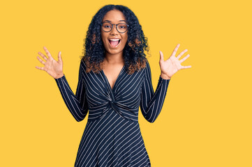 Young african american woman wearing casual clothes and glasses celebrating crazy and amazed for...