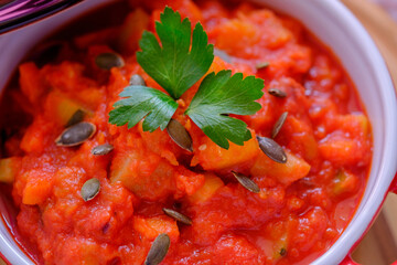 Vegetable stew in a beautiful red saucepan.