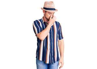 Young handsome caucasian man wearing summer hat tired rubbing nose and eyes feeling fatigue and headache. stress and frustration concept.