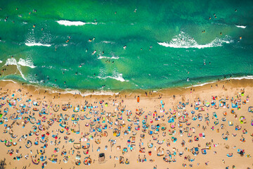 Crowded beach on Baltic Sea during pandemic, aerial view