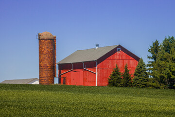 Fototapeta na wymiar Red barn and silo in rural America