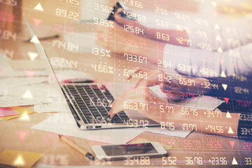 Multi exposure of woman hands typing on computer and financial chart hologram drawing. Stock market analysis concept.