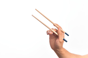 Hand of caucasian young man holding chopsticks over isolated white background