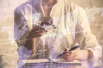 Double exposure of financial graph sketch hologram and woman holding and using a mobile device. Stock exchange concept.