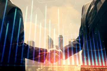 Double exposure of forex graph hologram and handshake of two men. Stock market concept.