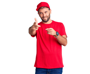 Fototapeta na wymiar Young handsome blond man wearing t-shirt and cap pointing fingers to camera with happy and funny face. good energy and vibes.