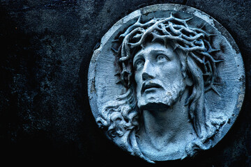 Jesus Christ in a crown of thorns. Fragment of an ancient statue.