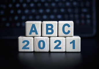 ABC - text in 2021 concept. Wooden cubes on a black keyboard