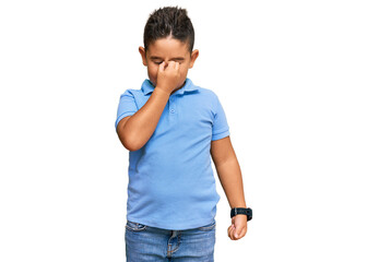 Little boy hispanic kid wearing casual clothes tired rubbing nose and eyes feeling fatigue and...