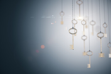 Fototapeta na wymiar Gold keys on rope on blurry gray background.