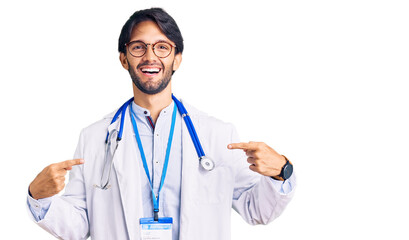 Handsome hispanic man wearing doctor uniform and stethoscope looking confident with smile on face,...