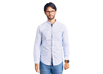 Fototapeta premium Handsome hispanic man wearing business shirt and glasses skeptic and nervous, frowning upset because of problem. negative person.