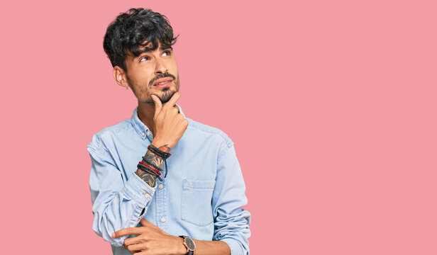 Young hispanic man wearing casual clothes thinking worried about a question, concerned and nervous with hand on chin