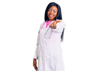 Young african american woman wearing doctor stethoscope smiling cheerful offering palm hand giving assistance and acceptance.