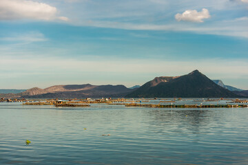 The Taal volcano complex and fish pens at the lake. As seen form the town of Laurel.