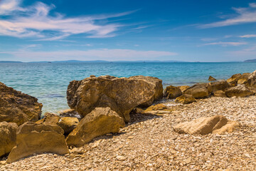 Fototapeta na wymiar Rocky beach and rocky fragments on the Adriatic coast near the city of Split in Croatia
