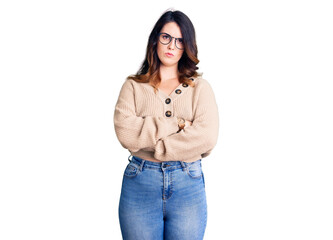 Beautiful young brunette woman wearing casual clothes and glasses skeptic and nervous, disapproving expression on face with crossed arms. negative person.