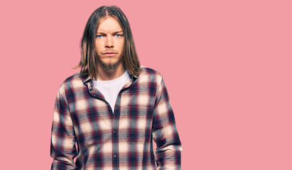 Fototapeta premium Handsome caucasian man with long hair wearing hipster shirt skeptic and nervous, frowning upset because of problem. negative person.