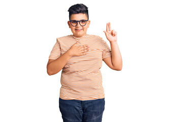 Little boy kid wearing casual clothes and glasses smiling swearing with hand on chest and fingers...