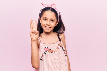 Obraz na płótnie Canvas Beautiful child girl wearing casual clothes showing and pointing up with fingers number three while smiling confident and happy.